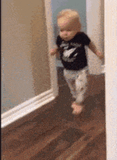 A toddler walking slowly into the room, caught out